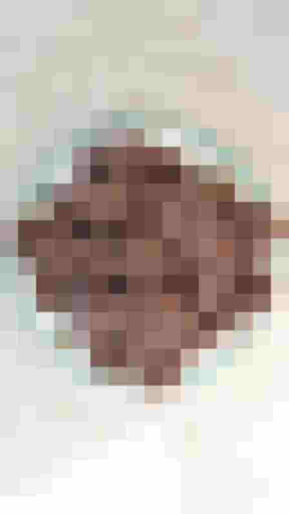 Schokoladige Aronia-Taler auf einem dekorativen Teller, zum Naschen geeignet.